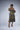 Brown girl wearing a purple and yellow cut out midi dress