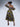 Brown girl wearing a purple and yellow cut out midi dress