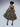 Brown girl wearing a purple and yellow cut out midi dress