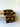 Brown earth toned authentic Bogolan fabric on a wooden surface with a light background